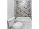 The bathroom has a tiled shower/tub with white fixtures and marble-patterned tile at 191 Davis Ct, Hiram, GA 30141