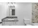 This bathroom features a granite vanity, framed mirror, and a tiled shower/tub at 191 Davis Ct, Hiram, GA 30141