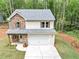 Charming two-story home with stone and siding exterior, a two-car garage and well-manicured lawn at 191 Davis Ct, Hiram, GA 30141