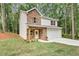 Charming two-story home featuring a stone facade, light siding, and an attached two-car garage in a lush, wooded setting at 191 Davis Ct, Hiram, GA 30141