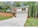 Charming two-story home featuring a stone facade, light siding, and an attached two-car garage in a lush, wooded setting at 191 Davis Ct, Hiram, GA 30141