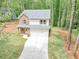 Charming two-story home with stone accents, a two-car garage, and well-maintained front yard, set amongst mature trees at 191 Davis Ct, Hiram, GA 30141
