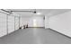 A clean, spacious two-car garage with white walls and concrete flooring, offering ample parking at 191 Davis Ct, Hiram, GA 30141