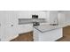 Bright kitchen features white cabinets, stainless steel appliances and granite countertops at 191 Davis Ct, Hiram, GA 30141