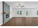 Spacious living room features a decorative fireplace, ample natural light, and modern flooring, ideal for entertaining at 191 Davis Ct, Hiram, GA 30141