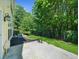 The backyard features a small patio, landscaped mulch beds, and a fenced wooded area at 220 Finchley Dr, Roswell, GA 30076