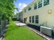 View of the house and fenced backyard, featuring a small patio and landscaping at 220 Finchley Dr, Roswell, GA 30076