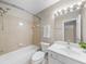 Bright bathroom features a shower-tub combo, vanity, and a large mirror with lights at 220 Finchley Dr, Roswell, GA 30076