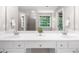 Bathroom with double vanity, sinks, mirrors, neutral colored walls, and natural light at 220 Finchley Dr, Roswell, GA 30076