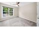 Neutral bedroom with a ceiling fan and large window providing plenty of natural light at 220 Finchley Dr, Roswell, GA 30076