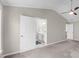Primary bedroom with connected bathroom and neutral colored walls at 220 Finchley Dr, Roswell, GA 30076