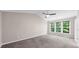 Spacious bedroom with carpet, neutral colored walls, fan, and natural light from windows at 220 Finchley Dr, Roswell, GA 30076