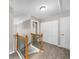 Hallway with wood railing staircase, carpeting, and neutral colored walls at 220 Finchley Dr, Roswell, GA 30076