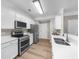 Modern kitchen featuring stainless steel appliances, sleek countertops, and ample cabinet space at 220 Finchley Dr, Roswell, GA 30076