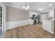 Bright kitchen with stainless steel appliances, white cabinets, and a sliding glass door to the outside at 220 Finchley Dr, Roswell, GA 30076
