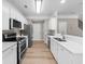 Modern kitchen featuring stainless steel appliances, sleek countertops, and ample cabinet space at 220 Finchley Dr, Roswell, GA 30076