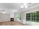Bright living room with fireplace, windows and a sliding glass door to the backyard at 220 Finchley Dr, Roswell, GA 30076