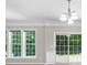 Bright living room with windows and a sliding glass door to the backyard at 220 Finchley Dr, Roswell, GA 30076