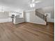 Open-concept living room with sleek floors and view of kitchen at 220 Finchley Dr, Roswell, GA 30076