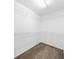 This carpeted walk-in closet provides ample storage with its white shelving at 220 Finchley Dr, Roswell, GA 30076