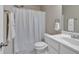 Clean bathroom with white cabinets, sink and fixtures, with a shower featuring a white shower curtain at 2767 Camp Mitchell Rd, Loganville, GA 30052