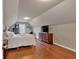 Bedroom featuring slanted ceilings, hardwood floors and a flatscreen television at 2767 Camp Mitchell Rd, Loganville, GA 30052
