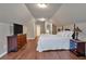Spacious bedroom featuring hardwood floors, chest of drawers, a queen bed and lots of closet space at 2767 Camp Mitchell Rd, Loganville, GA 30052