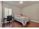Cozy bedroom featuring hardwood floors, a comfortable bed, and a window-side desk area at 2767 Camp Mitchell Rd, Loganville, GA 30052