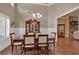Formal dining room features hardwood floors, neutral walls, natural light, and elegant table set at 2767 Camp Mitchell Rd, Loganville, GA 30052