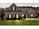 Charming single-Gathering home at dusk featuring manicured lawn, inviting curb appeal, and symmetrical window placement at 2767 Camp Mitchell Rd, Loganville, GA 30052
