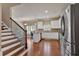 Bright kitchen with stainless appliances, eat-in breakfast nook, and wood staircase at 2767 Camp Mitchell Rd, Loganville, GA 30052