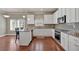 Well-lit kitchen with white cabinets, stainless steel appliances, granite countertops, and a breakfast bar at 2767 Camp Mitchell Rd, Loganville, GA 30052