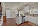 Modern eat-in kitchen with granite countertops, a stainless steel dishwasher, and white cabinetry at 2767 Camp Mitchell Rd, Loganville, GA 30052