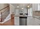 Bright kitchen featuring granite countertops, stainless steel appliances, and beautiful hardwood floors at 2767 Camp Mitchell Rd, Loganville, GA 30052