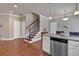 Bright kitchen featuring granite countertops, stainless steel appliances, and beautiful hardwood floors at 2767 Camp Mitchell Rd, Loganville, GA 30052