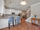 Bright and inviting kitchen with white cabinets, pendant lighting, and breakfast bar seating at 2767 Camp Mitchell Rd, Loganville, GA 30052