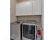 Well-equipped laundry room with modern washer and dryer and ample storage space at 2767 Camp Mitchell Rd, Loganville, GA 30052