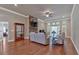 Open living room boasts hardwood floors, stone fireplace, built-in cabinet, and recessed lights at 2767 Camp Mitchell Rd, Loganville, GA 30052