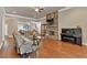 Open-concept living room features a stacked stone fireplace, hardwood floors, and ample natural light at 2767 Camp Mitchell Rd, Loganville, GA 30052
