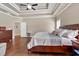 Spacious bedroom boasts a trey ceiling, ceiling fan, wood floors and dark wood furniture at 2767 Camp Mitchell Rd, Loganville, GA 30052