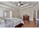 Spacious main bedroom with tray ceilings, wood floors, and a seating area at 2767 Camp Mitchell Rd, Loganville, GA 30052