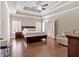 Spacious main bedroom with tray ceilings, wood floors, and a seating area at 2767 Camp Mitchell Rd, Loganville, GA 30052