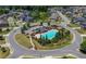 Aerial view of a community pool, playground, and neighborhood streets at 5465 Mirror Lake Dr, Cumming, GA 30028