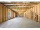 Unfinished basement with a concrete floor and exposed wood framing at 5465 Mirror Lake Dr, Cumming, GA 30028