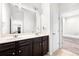 Bathroom with a double sink vanity and an entrance into the walk in closet at 5465 Mirror Lake Dr, Cumming, GA 30028