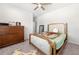 Cozy bedroom with neutral carpet, a dresser, and an accent mirror at 5465 Mirror Lake Dr, Cumming, GA 30028
