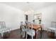 Dining room featuring hardwood floors, white walls, and a large window at 5465 Mirror Lake Dr, Cumming, GA 30028
