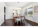Elegant dining room with wood floors, modern chandelier, and bright window at 5465 Mirror Lake Dr, Cumming, GA 30028