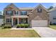 Charming two-story brick home featuring a welcoming front porch and well-manicured landscaping at 5465 Mirror Lake Dr, Cumming, GA 30028