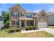 Attractive two-story brick home with a well-kept lawn, attached garage, and inviting curb appeal at 5465 Mirror Lake Dr, Cumming, GA 30028
